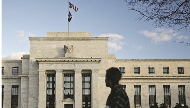 A pedestrian walks past the Federal Reserve building in Washington, DC. The US economyu2019s readiness or not for an interest rate rise is likely to once again take the global economic spotlight this week, just a month before the US presidential election.