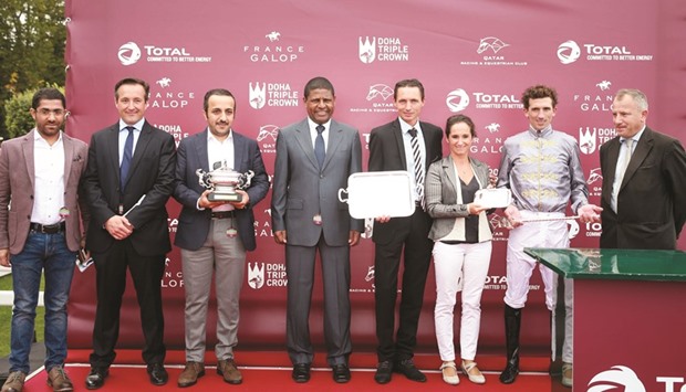 Yousuf al-Nisf presents the trophies to the winners in the Qatar Total Arabian Trophy for Colts after Motrag won the race.