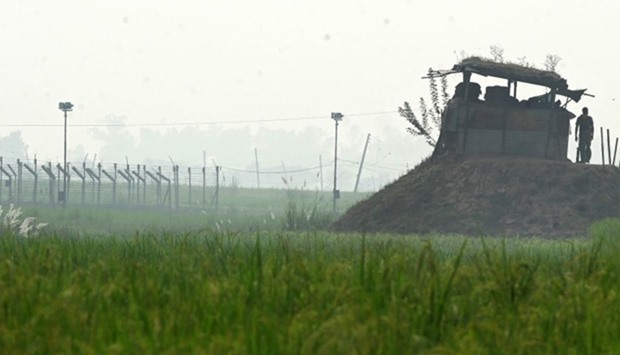 An Indian Border Security Force (BSF) soldier looks on from his post along the India-Pakistan border