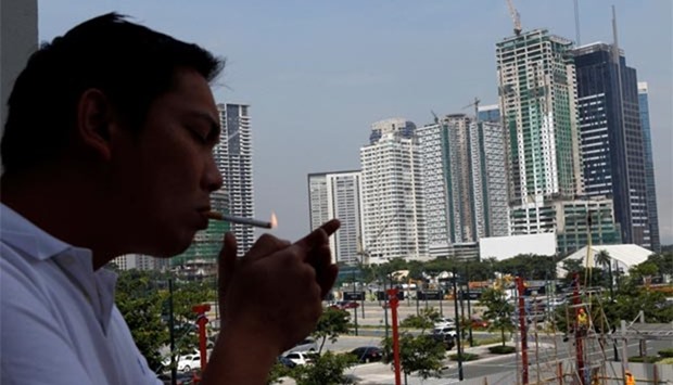 A man lights a cigarette at Bonifacio Global City in Taguig, Metro Manila in this file picture.