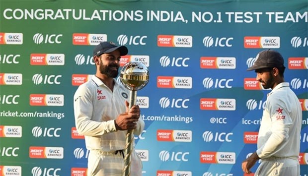 Virat Kohli holds the ICC Number 1 Test cricket team trophy after winning the series against New Zealand at the Holkar Stadium in Indore on Tuesday.