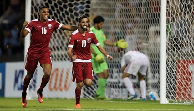 Qatar's Hasan al-Haydos (centre) celebrates after scoring a penalty during the 2018 World Cup qualifying match against Syria at the Jassim Bin Hamad Stadium in Doha on Tuesday. 