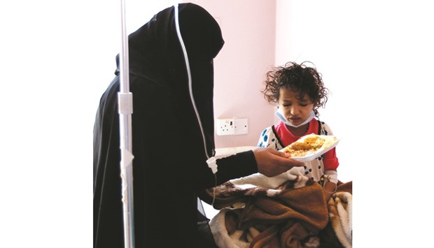 A Yemeni girl is given food by her mother at a hospital in the capital Sanaa yesterday. The World Heath Organisation said it had confirmed 11 cases of cholera in Sanaa, after the UN announced an outbreak of the disease last week.