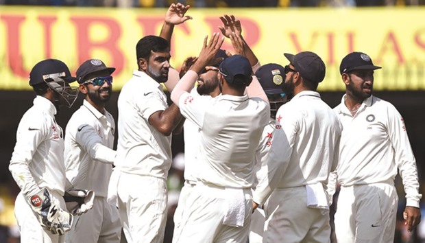 Ravichandran Ashwin (3rd left) celebrates with teammates after dismissing New Zealand captain Kane Williamson (not in pic) during the fourth dayu2019s play of the third Test at the Holkar Stadium in Indore yesterday. (AFP)