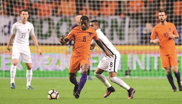 Midfielder Georginio Wijnaldum (left) limped out of the Netherlandu2019s World Cup qualifying defeat by France in Amsterdam on Monday night with a problem in his right hamstring. (AFP)