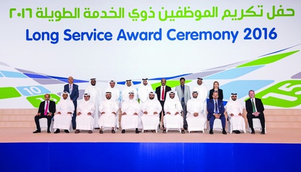 Al-Muhannadi with employees who have put in more than 20 years of service
