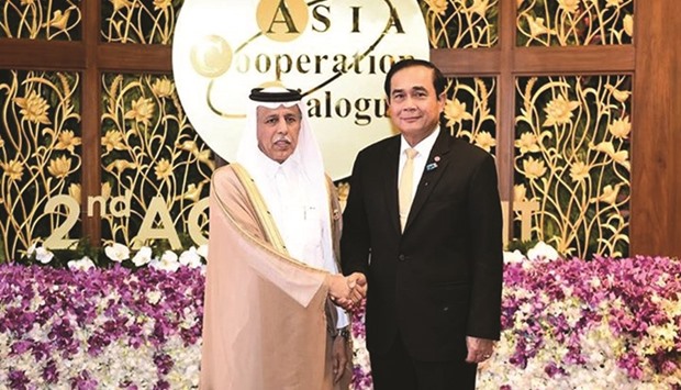 Al-Mahmoud with Prayut Chan-ocha in Bangkok.