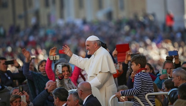 Pope Francis waves as he arrives to lead his Wednesday general audience in Saint Peter's square at the Vatican October 12, 2016