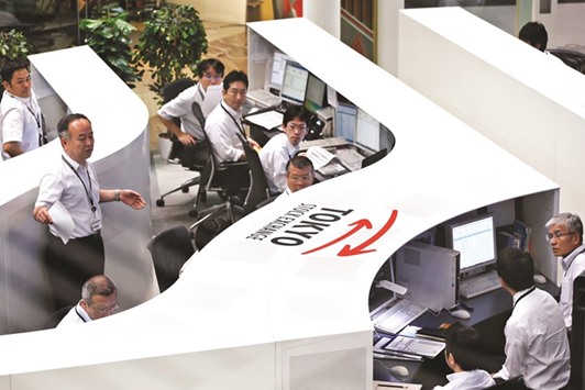 Employees work at the  Tokyo Stock Exchange. The Nikkei 225 closed down 1.1% to 16,840.00 points yesterday.