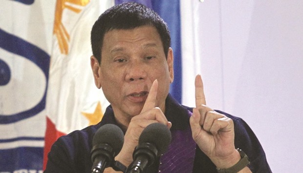 President Rodrigo Duterte gestures while delivering a speech before female police officers during a gathering in Davao city.