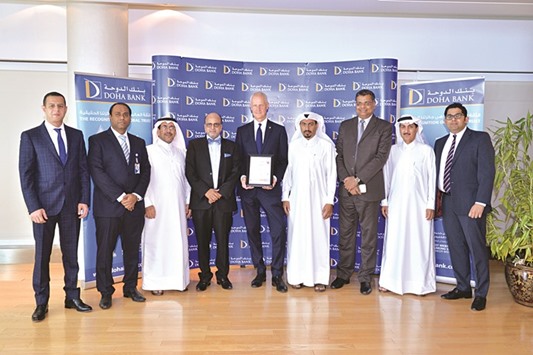 Doha Bank officials with the ISO 9001:2015 certification.