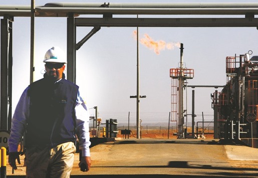 An employee walks in front of a gas flare at the In Salah Gas Krechba Project, run by Sonatrach, BP, and StatoilHydro, in the Sahara desert near In Salah, Algeria (file). Sonatrach is looking to capitalise on booming natural gas demand from nations including Egypt and Jordan amid efforts to boost its own production.