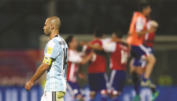 Argentinau2019s Javier Mascherano leaves as Paraguayu2019s players celebrate winning the match.