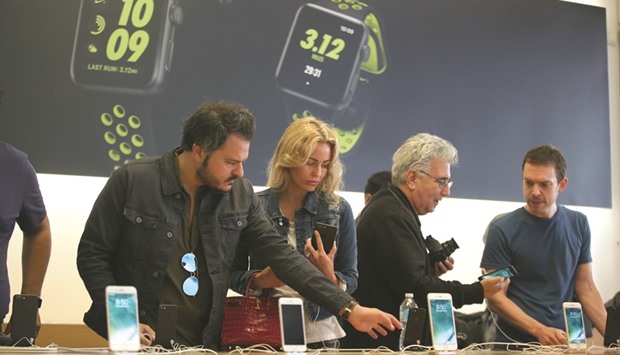 Customers look at the new iPhone 7 smartphones inside a store in Los Angeles. The Osaka-based companyu2019s general strategy is to increase the competition on the supply side, and dilute the risk exposure to one company, sources said.