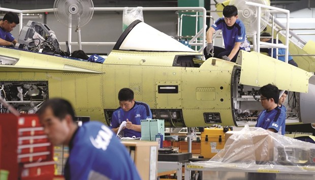 Engineers assemble a FA-50, South Koreau2019s first home-built light fighter, at an assembly plant of the Korea Aerospace Industries in Sacheon. The countryu2019s shipments to China fell 9.1 %, while those to the US and the EU slumped 6.1% and 14.5%, respectively, data showed yesterday.