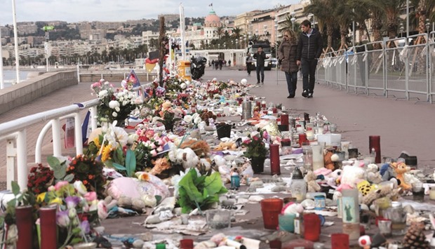 People walk past a memorial to the victims of the July 14 attack on the Promenade des Anglais, two days before a national tribute in Nice.