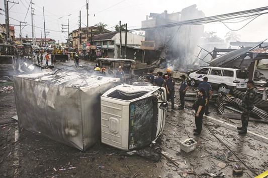 A truck was turned over after an explosion during a fire at fireworks shop in Bocaue, Bulacan, north of Manila, yesterday.