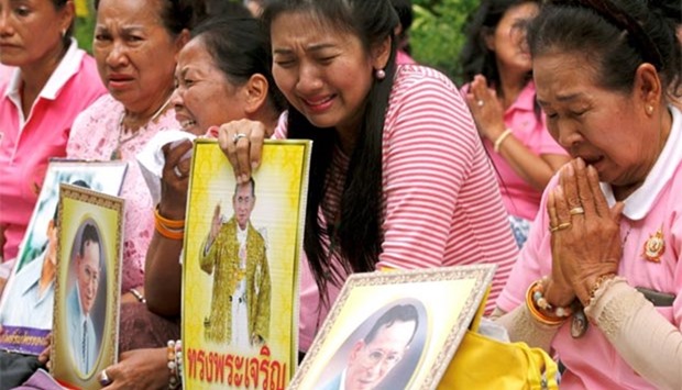 Well-wishers weep as they pray for Thailand's King Bhumibol Adulyadej at the Siriraj hospital in Bangkok on Thursday.