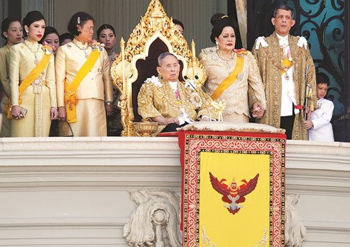 Thailandu2019s King Bhumibol Adulyadej is accompanied by Queen Sirikit, crown prince Maha Vajiralongkorn, princess Maha Chakri Sirindhorn, princess Chulabhorn and other members of the royal family as he delivers his birthday speech from the balcony of the Grand Palace in Bangkok, Thailand on December 5, 2011.