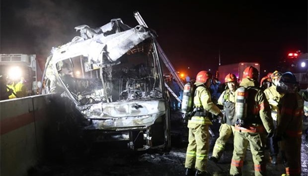 Fire and rescue services attend the scene of a bus accident near Ulsan on Friday.