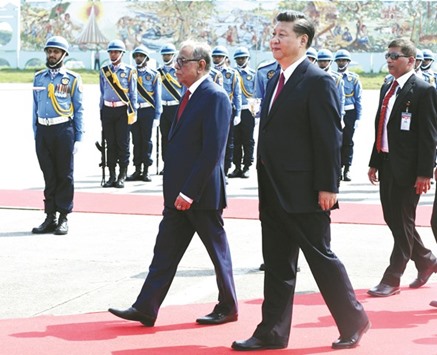 Chinese President Xi Jinping, right, walks with Bangladeshu2019s President Abdul Hamid after arriving in Dhaka yesterday.