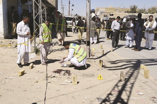 Investigators collect evidence after an attack on Frontier Constabulary personnel in Quetta yesterday.