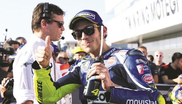 Movistar Yamaha MotoGPu2019s Italian rider Valentino Rossi gestures at the parc ferme after getting the pole position during the qualifying sessio at the Japanese Grand Prix in the Twin Ring Motegi circuit in Motegi yesterday. (AFP)