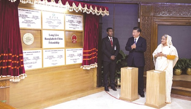 Chinese President Xi Jinping, second right, and Bangladeshi Prime Minister Sheikh Hasina attend an inauguration for co-operative projects between the two countries after their talks in Dhaka.
