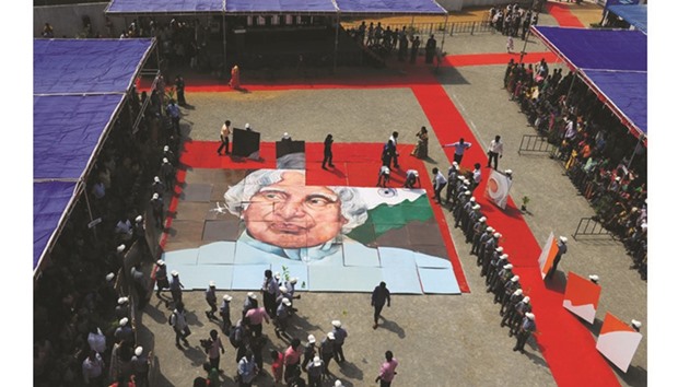 School children piece together an image of Kalam during a remembrance event on his 85th birth anniversary at a school in Chennai yesterday.