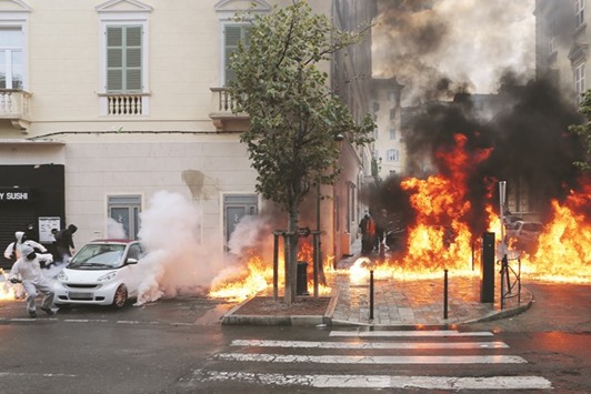 Anti-riot police (on the right) clash with protesters (left) throwing Molotov cocktails in Bastia on the French Mediterranean island of Corsica.