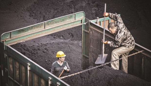 Employees unload coal from a truck at a coal mine and processing facility in Liulin, Shanxi province, China. A continued slowdown at Chinese mines would extend a 54% rally in European coal this year. That, in turn, will force natural gas prices higher in the region. If this combines with a revival in US coal, it could make Gulf Coast LNG exports competitive in Europe.