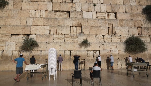 Jewish worshippers pray at the Western wall