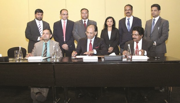 K M Varghese and Rajiv Kumar Gupta, flanked by officials from the Indian embassy and IBPN, at the signing ceremony in Doha.