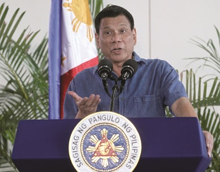 President Rodrigo Duterte gestures while delivering a message before leaving for Brunei at the Davao International Airport yesterday.