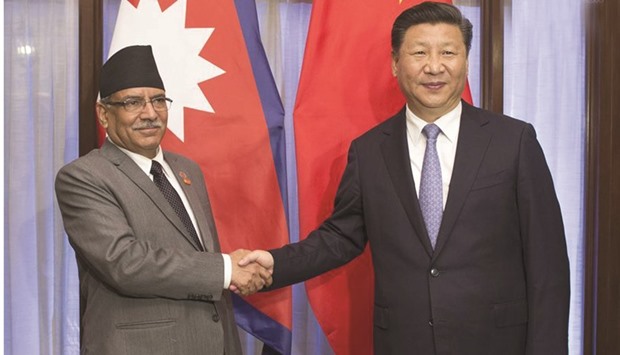 Chinese President Xi Jinping, right, meets with Nepal Prime Minister Pushpa Kamal Dahal in the western Indian state of Goa.
