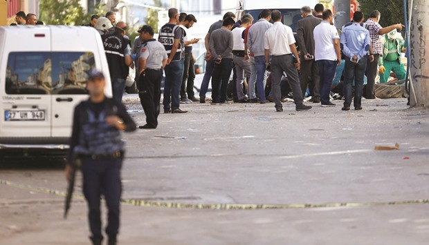 Police forensic experts examine a blast site, and at an apartment (right) in Gaziantep.