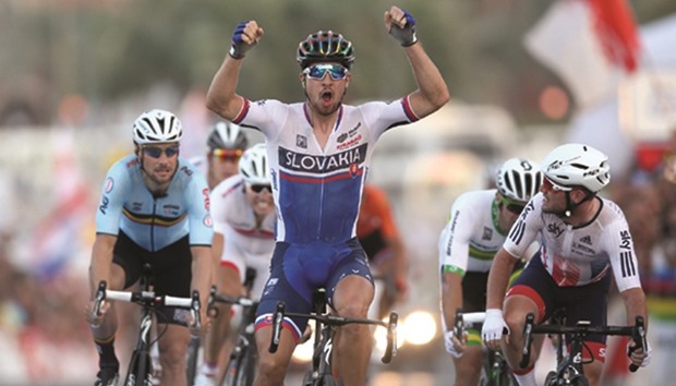 Slovakiau2019s Peter Sagan (third from left) celebrates as he crosses the finish line ahead of Britainu2019s Mark Cavendish (right) and Belgiumu2019s Tom Boonen (second from left) to win the UCI Road World Championships 2016 menu2019s road race title at The Pearl yesterday.