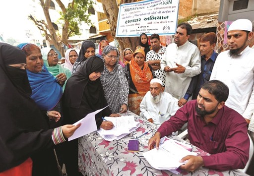Muslim women line up to sign forms to support the All India Muslim Personal Law Board (AIMPLB) during a signature campaign in Ahmedabad yesterday.