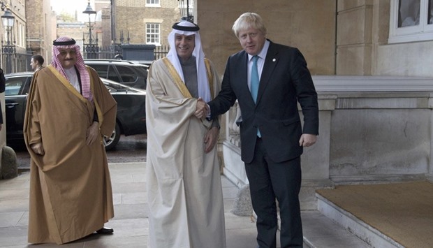 Saudi Arabia's Foreign Minister Adel al-Jubeir (C) is greeted by Britain's Foreign Secretary Boris Johnson ahead of a meeting at Lancaster House, in London