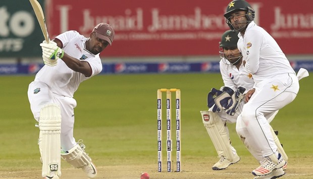 West Indies batsman Darren Bravo (left) plays a shot en route to a brilliant hundred on the final day of the first day-night Test against Pakistan at the Dubai International Cricket Stadium in the Gulf Emirate yesterday. (AFP)