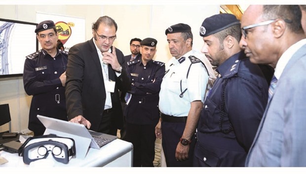 Officials from the Ministry of Interior visiting an exhibition held on the sidelines of the Qatar Transport Safety Forum.