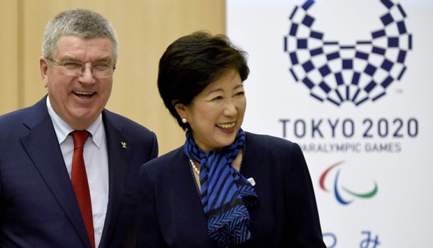 International Olympic Committee (IOC) President Thomas Bach (L) beside Tokyo Governor Yuriko Koike 