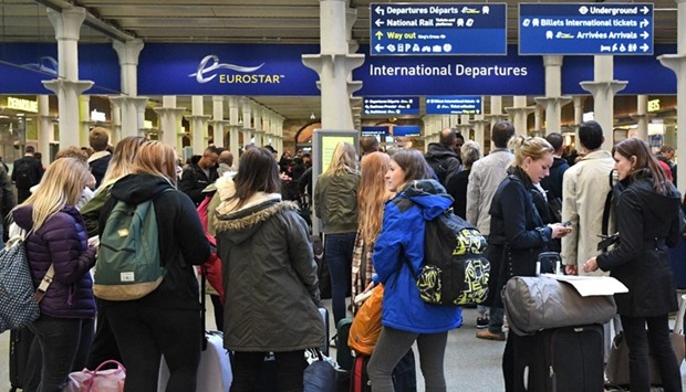 Passengers wait near the International Departures area at the Eurostar terminal at London St Pancras train station in London
