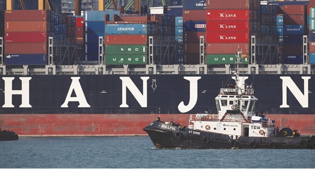 A tugboat passes Hanjin Hungary container ship at Tanjong Pagar terminal in Singapore. A court overseeing Hanjin Shippingu2019s receivership said the five ships up for sale each had a cargo capacity of about 6,500 twenty-foot equivalent units (TEUs).