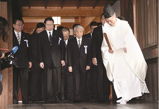 A Shinto priest leads lawmakers at the Yasukuni Shrine.