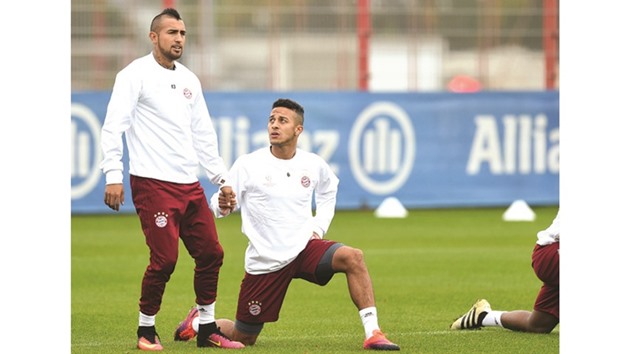 Bayern Munichu2019s Thiago Alcantara and Arturo Vidal (left) speak during training in Munich. (AFP)