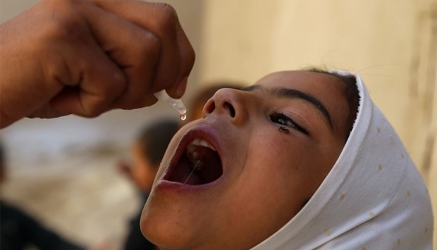 Health worker administers the polio vaccine to a child during a vaccination