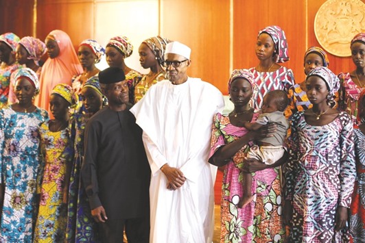 President Muhammadu Buhari and Vice President Yemi Osinbajo host some of the 21 Chibok schoolgirls released by Boko Haram.