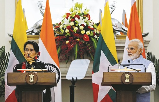 Myanmaru2019s State Counsellor Aung San Suu Kyi reads a joint statement as Prime Minister Narendra Modi looks on at Hyderabad House in New Delhi, yesterday.