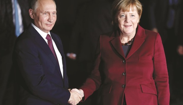 German Chancellor Angela Merkel welcomes Russian President Vladimir Putin at the chancellery in Berlin.